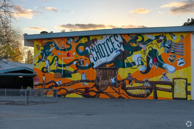 Sun sets over colorful mural at Will C. Wood Middle School.