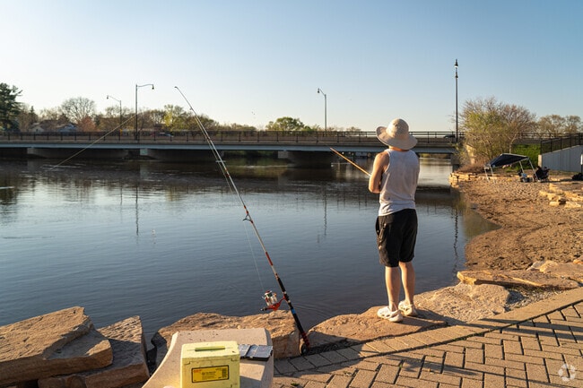 Locals fish on the Fox River at Veterans Island Park near the Light of the Community area.