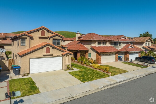Some home exteriors feature stucco or brick with red clay shingles in Butterfield Ranch.