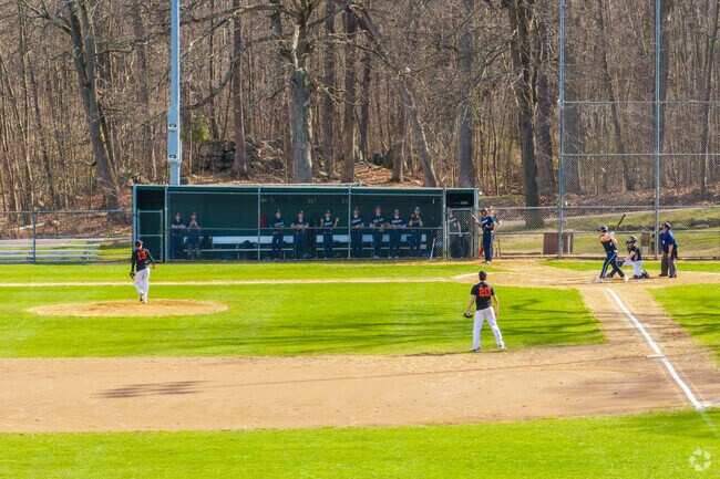 A baseball player hits the ball into the air at Tivnan Field, near Hamilton.