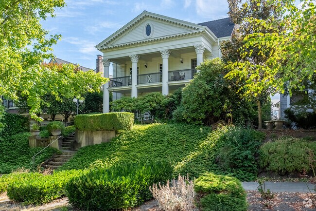 A majestic Colonial home near Roanoake Park in Portage Bay, with a beautifully lush front yard.