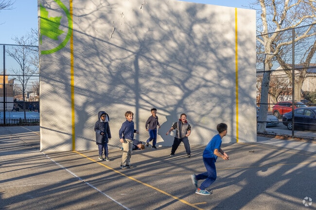 Local Howard Beach children enjoy a game of handball at Walter Ward Playground.