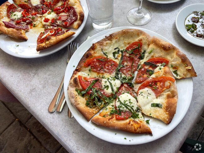 Wood-fired pizza is a very popular item on the menu at Figlio, a neighborhood restaurant.
