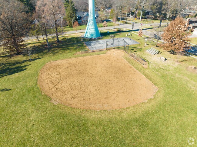 There is a baseball field and park near the school.