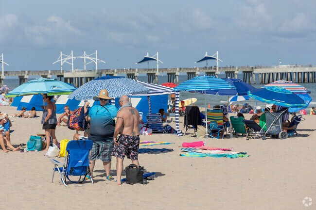 Beach goers flock to Pompano Beach for a tan and a swim.