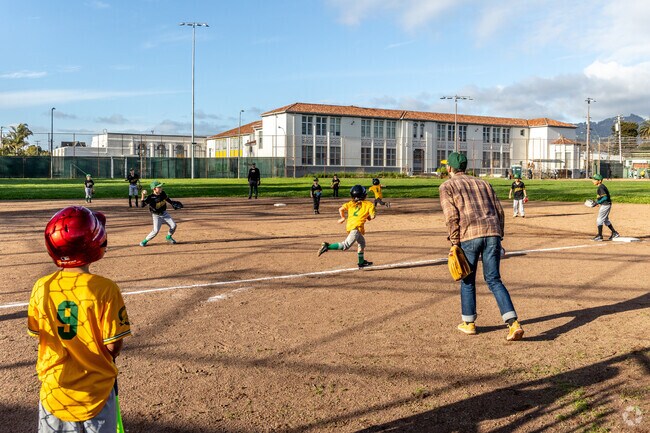 The baseball fields buzz with excitement on Oakland A's jr game nights in Paradis Park.