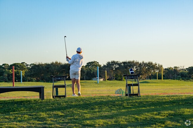Enjoying a round of golf, a resident takes a swing at Sailfish Sands Golf Club.