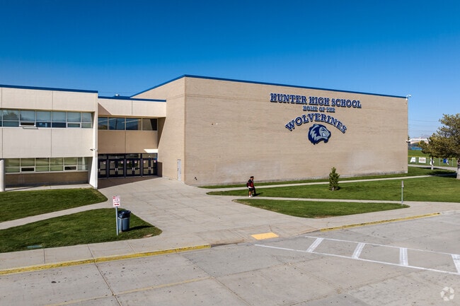 Hunter High School’s dark blue lettering stands out against its off white exterior walls.