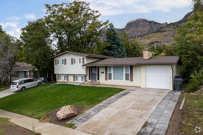 A classic family home in the mountains sits under a fall sky.