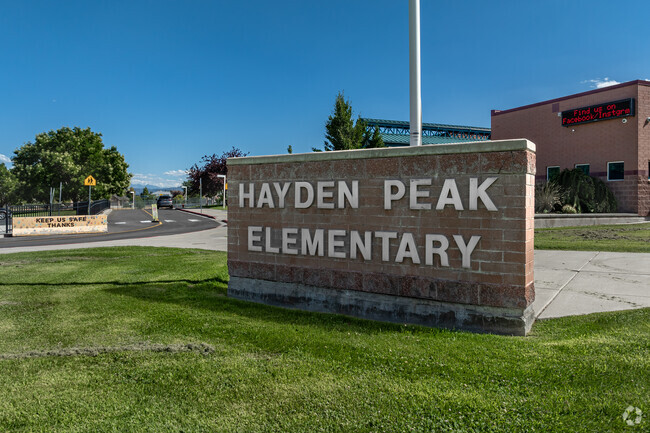 Trees shade a parking lot at Hayden Peak Elementary School.