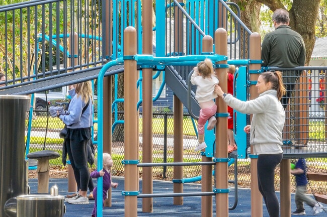 A young family enjoys playing together at nearby Dartmouth Park.
