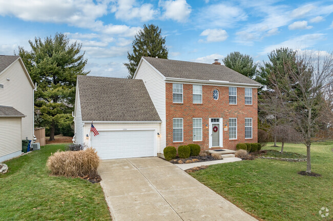 A colonial style home in Brookside Colony features a two-car attached garage.