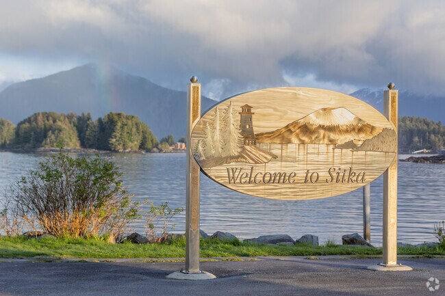 The handcrafted Welcome to Sitka sign stands proudly by the waterfront with island views.