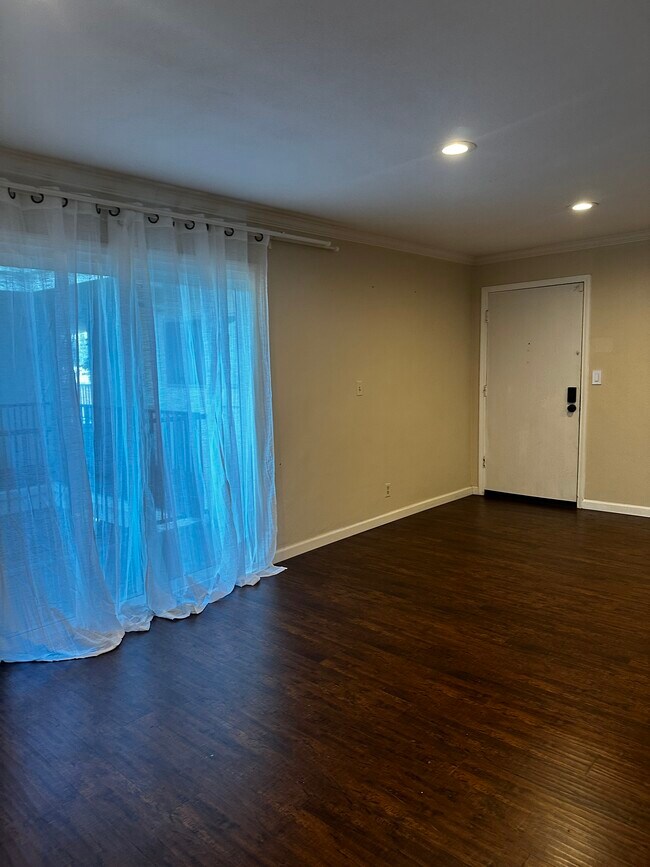 View of front door/balcony from living room