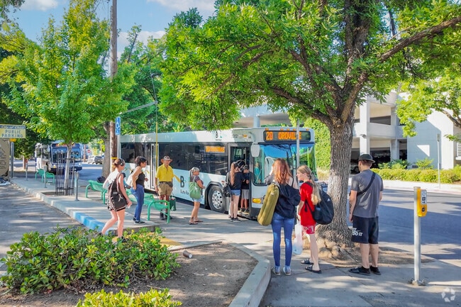 Residents wait at a bus stop in Chico's California Park neighborhood.