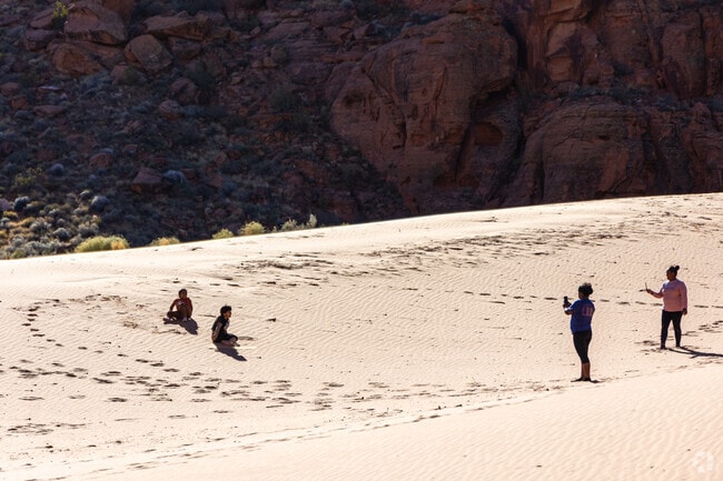 Families can visit the sand dunes in Snow Canyon State Park for some fun.