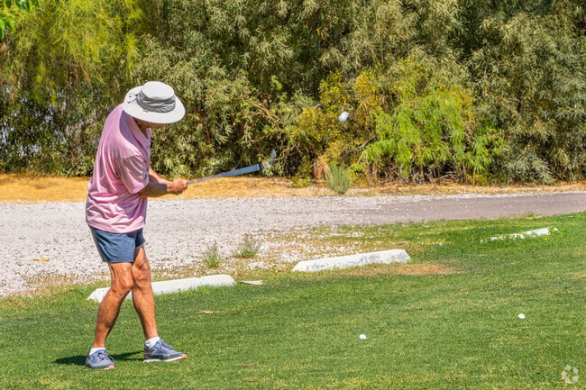 A golfer enjoys a sunny round at a nearby course, with Elephant Head's desert surroundings providing a tranquil backdrop.