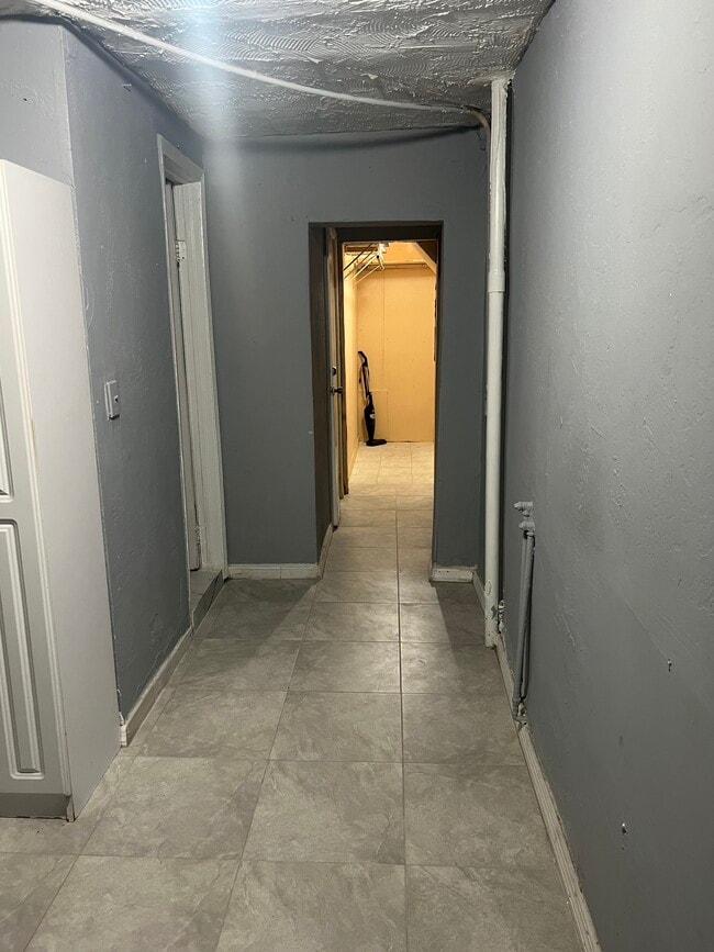 Hallway leads you to restroom & bedroom..