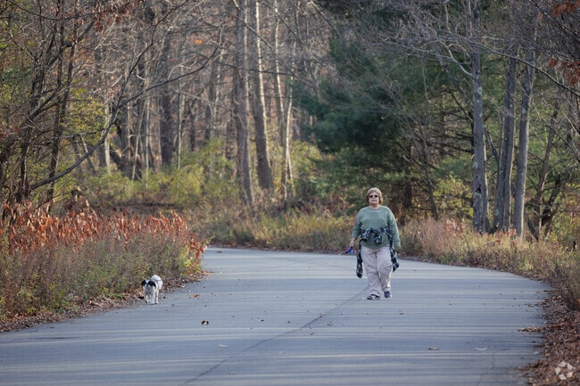 A woman walks her dog on the Lackawanna River Heritage Trail in Jermyn, PA.