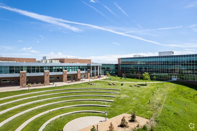 Students enjoy a large courtyard beside a lake at Westminster High School in Westminster, Colora