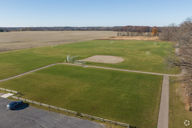 The Freer Park green space is surrounded by paved walking trails, popular with dog walkers.