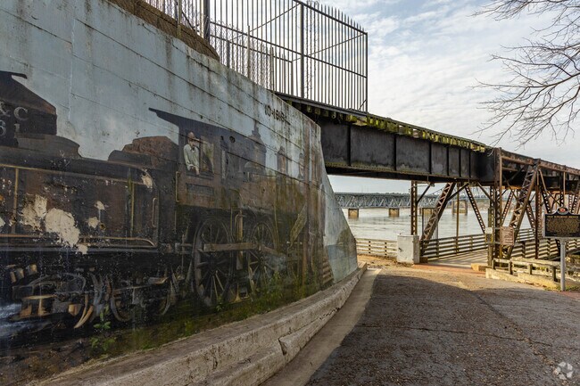 The Old Railroad Bridge mural highlights the history of railroads that once passed through The Shoals.