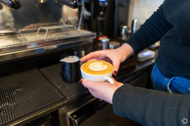 A barista at La Mulita Coffee in Hampton shows off latte art.