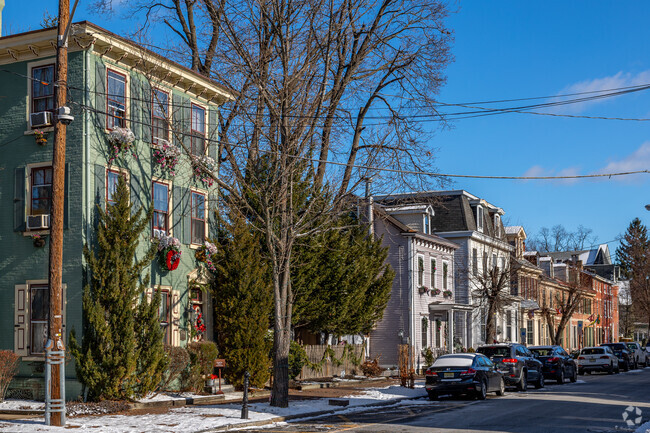 Townhomes in New Yorkshire stand three stories tall with Victorian features.
