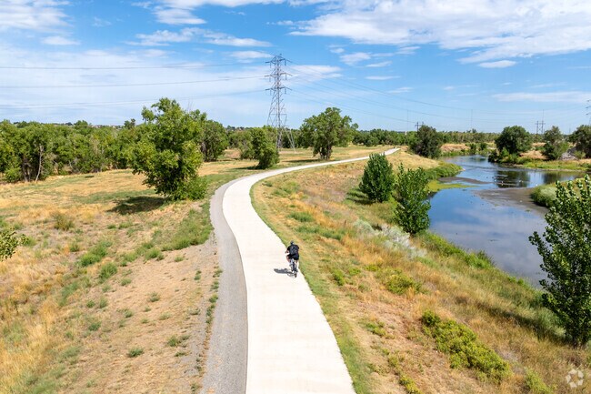 Cyclists admire the natural beauty of Pelican Pond’s 200 acres of open space.