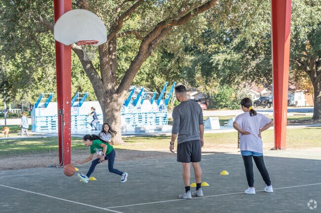 The park features sports fields, playgrounds, and walking trails.