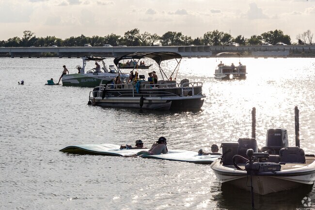 Summer nights in the Harbor District see boaters relaxing along the waters.