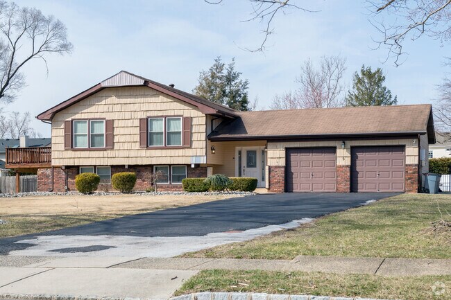 Variations on the traditional layout having a garage on the entry-level, the Manalapan Township neighborhood has a variety of splt-level houses with wonderful views.