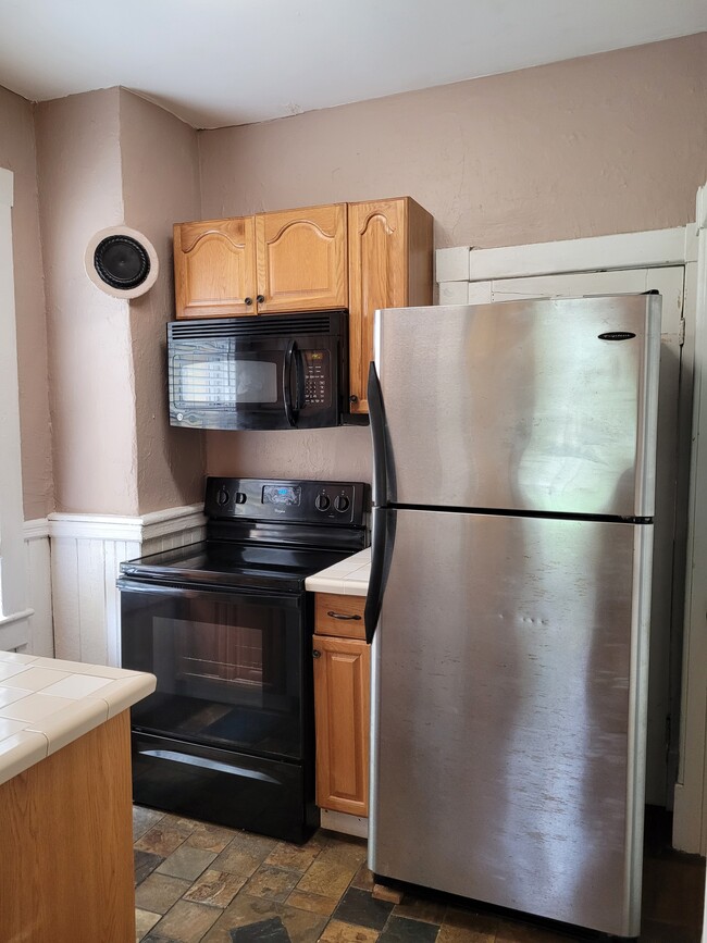 Kitchen-All Electric Appliances:Stainless fridge, glass-top stove, microwave/hood vent.Slate floor.