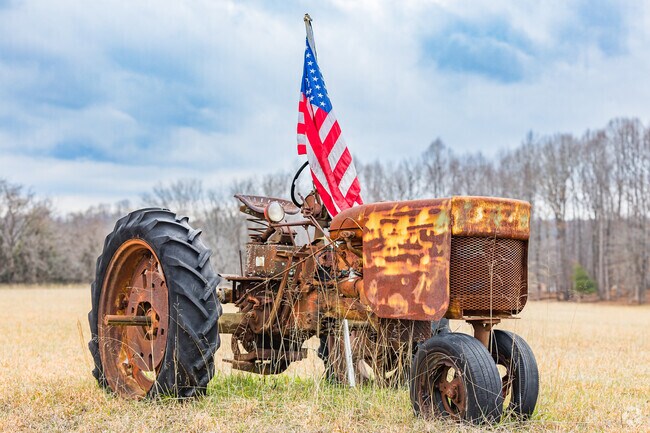 The Climax community is exemplified by an old rusted tractor and the American Flag.