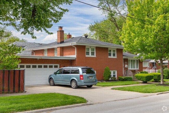 Tri-level brick homes are flanked with trees around Burnham, IL.