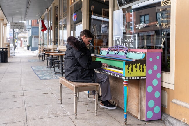 A person jams on a piano outside Markoh's on Main in Ayer's town center.