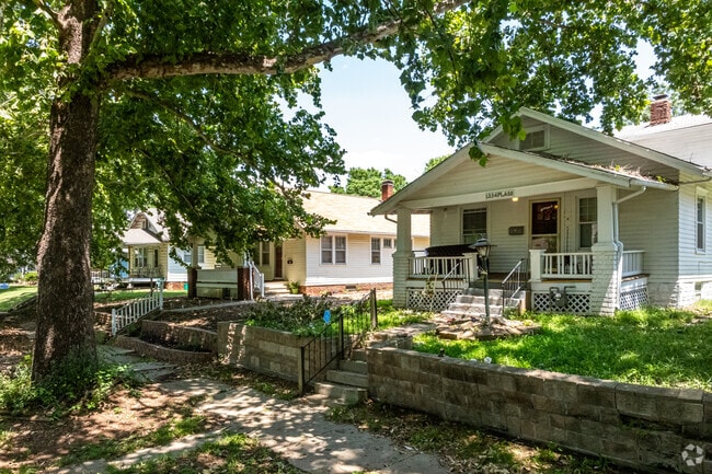 Sidewalks shaded by large oak trees flank at least one side of the roads in Norton.