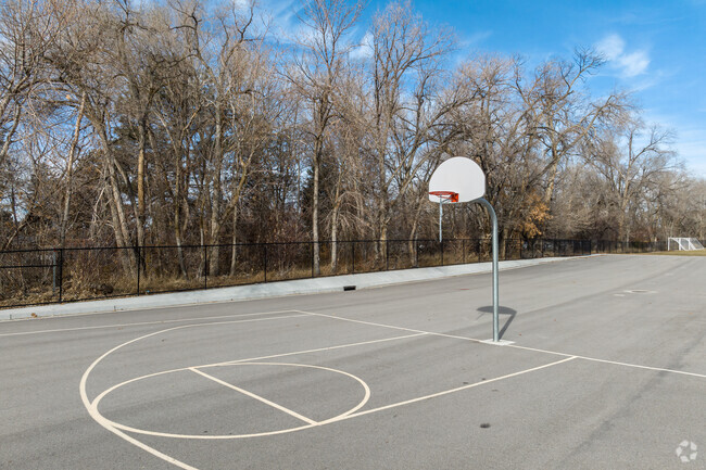 Basketball courts at Midvalley Elementary School is surrounded by mature trees.