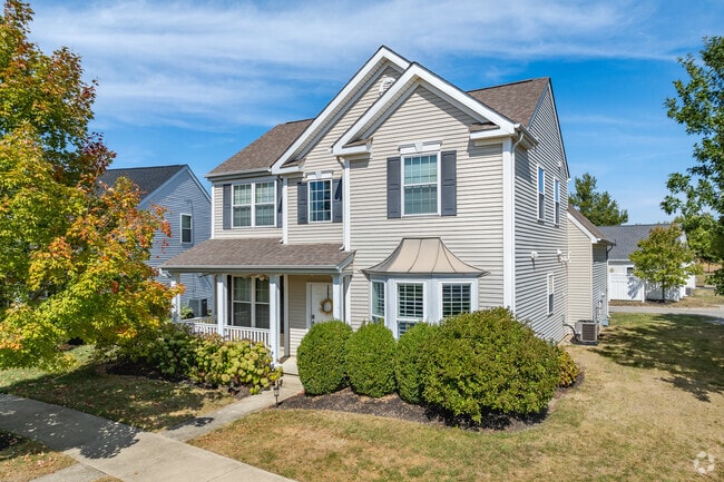 A two-story Traditional home in Tuttle West features a covered front porch.