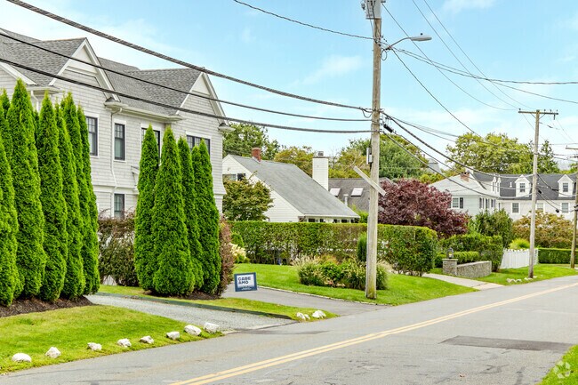 This row of homes in the Lily-Almy Pond neighborhood is typical of the area with green hedges.