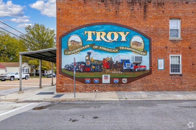 Locals and visitors alike admire the intricate details of Troy's stunning wall mural.