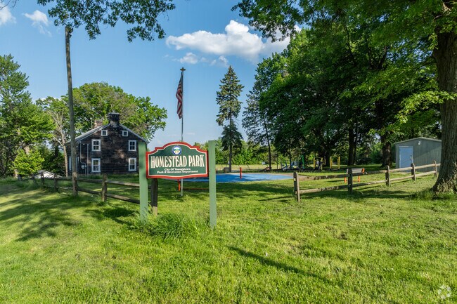 Locals enjoy the scenic charm of Homestead Park’s open green space and shaded benches.