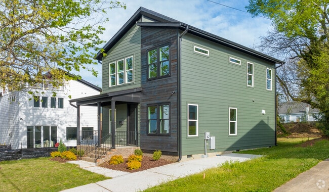 The streets of Olde East Raleigh lie along a gentle slope, with small grassy buffers between the sidewalks and roads.