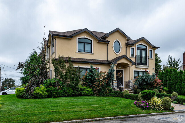 This beautifully manicured lawn helps invite you into the home in Albertson, NY.