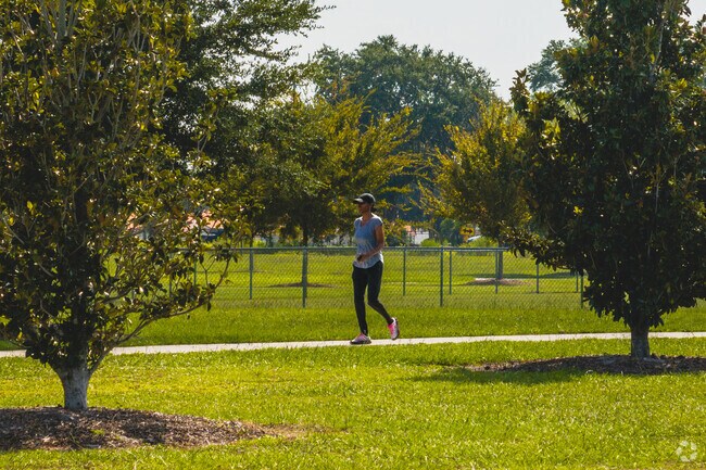 Walkers delight in the paved walking path that takes them around Douglas M Cook Park.