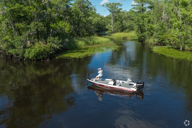 Some residents choose to fish by boat along the Waccamaw River in Red Hill.