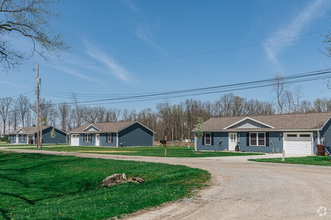 A row of nearly identical mid-century ranch homes lines a quiet street in Reynolds Heights.