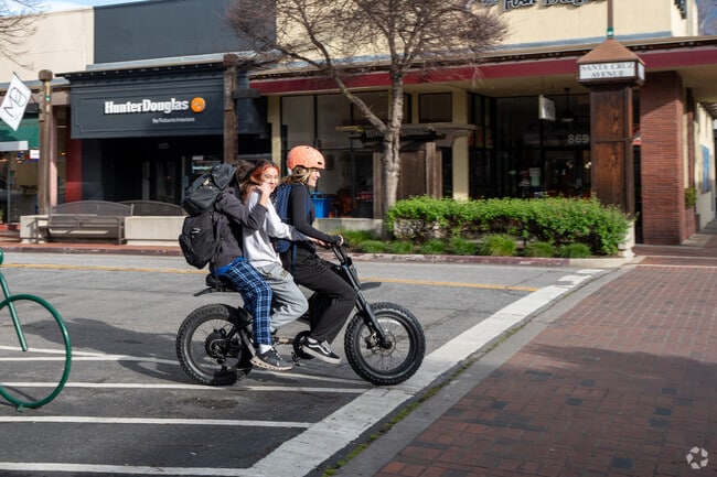 Kids joyfully ride their bicycles through Downtown Menlo Park's streets.