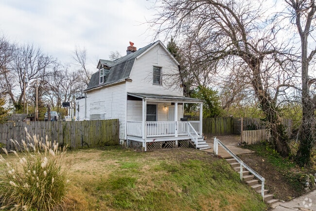 A gambrel roofed home sits atop a hill in Wells/Goodfellow.