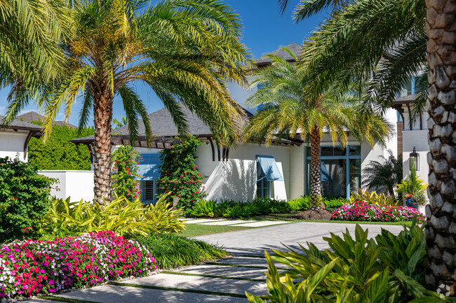 Colorful blooms and lush landscaping accent custom homes in Grey Oaks.